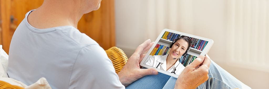 An older woman on a telehealth call with her doctor.