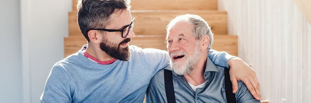 A senior man discusses assisted living with his son.