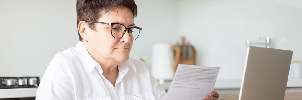 A senior reviews legal documents during the end-of-life planning process.