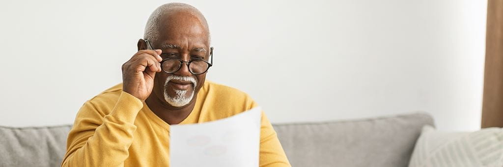 An older man reviews paperwork.
