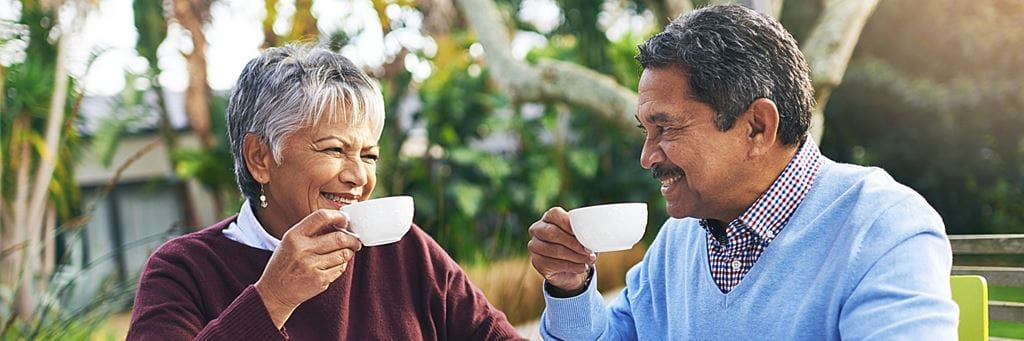 A retired couple drinks tea.
