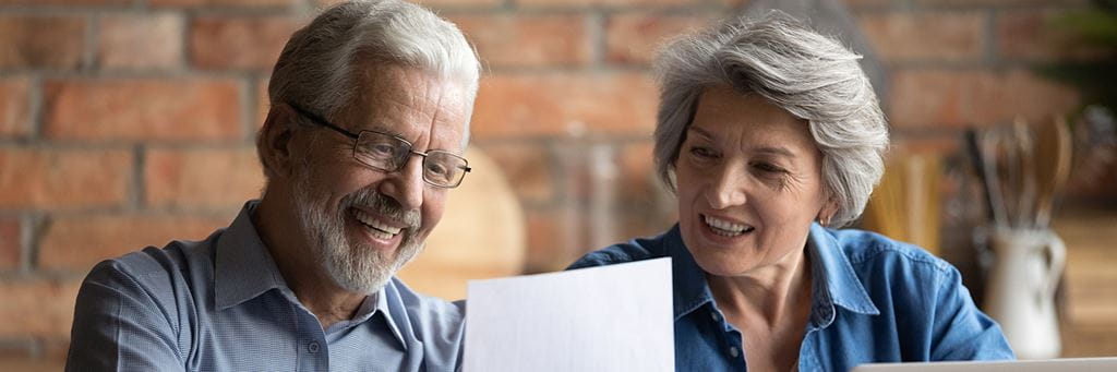 An older couple looks at paperwork together.