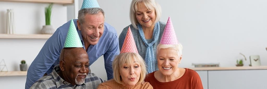 A Group of seniors wearing party hats.