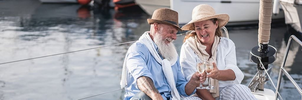 An older couple relaxes on a boat.