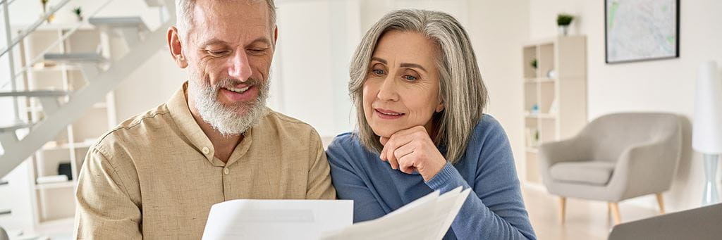 An older couple looks over paperwork.