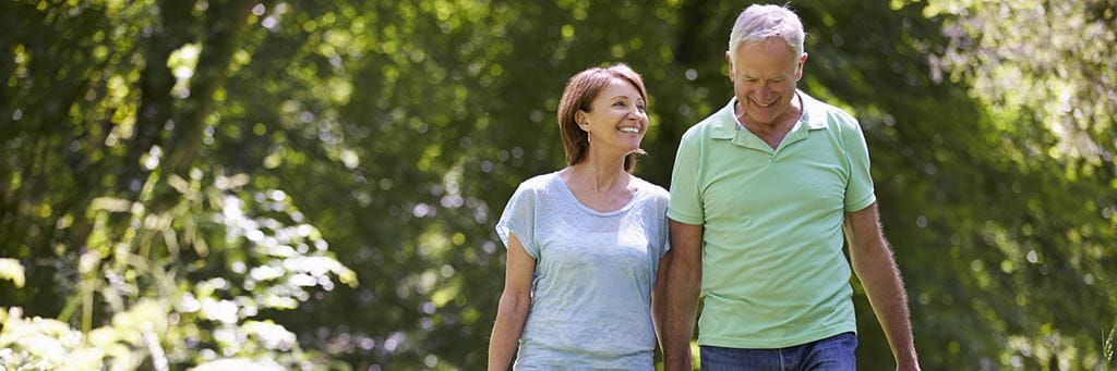 Senior couple walking talking about retirement
